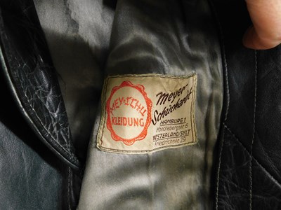 Lot 227 - A post WWII German dark green leather belted...