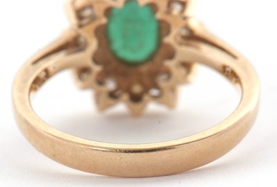 Lot 25 - An emerald and diamond cluster ring, set with...