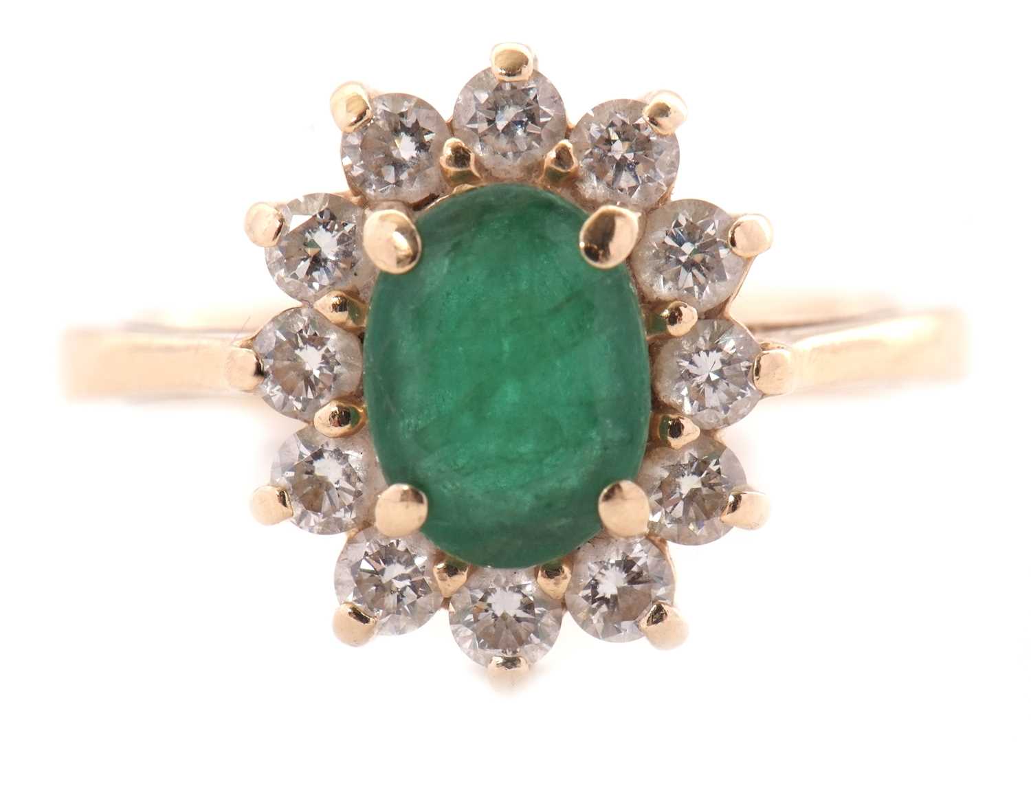 Lot 25 - An emerald and diamond cluster ring, set with...