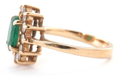 Lot 25 - An emerald and diamond cluster ring, set with...