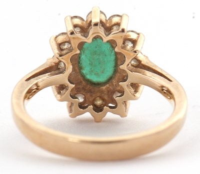 Lot 25 - An emerald and diamond cluster ring, set with...