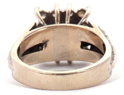 Lot 14 - An 18ct sapphire and diamond ring, the central...