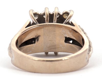 Lot 14 - An 18ct sapphire and diamond ring, the central...