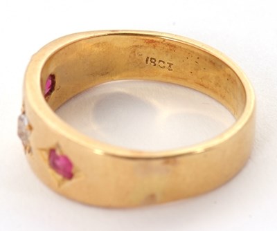 Lot 28 - A ruby and diamond ring, the 7mm deep band...