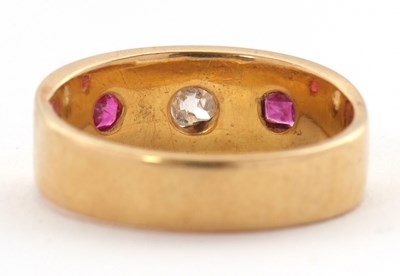 Lot 28 - A ruby and diamond ring, the 7mm deep band...