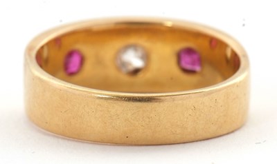 Lot 28 - A ruby and diamond ring, the 7mm deep band...