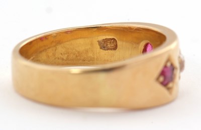 Lot 28 - A ruby and diamond ring, the 7mm deep band...