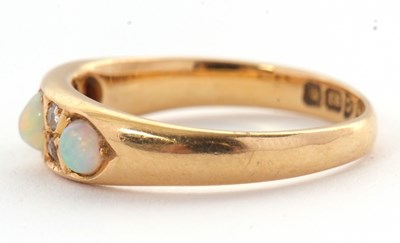 Lot 27 - An 18ct opal and diamond ring, set with three...