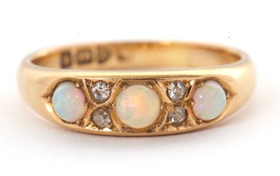Lot 27 - An 18ct opal and diamond ring, set with three...