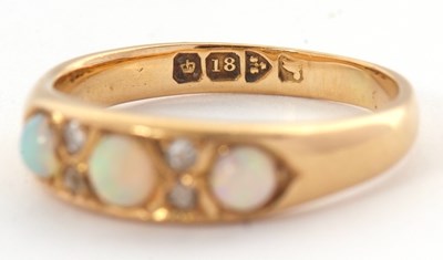 Lot 27 - An 18ct opal and diamond ring, set with three...