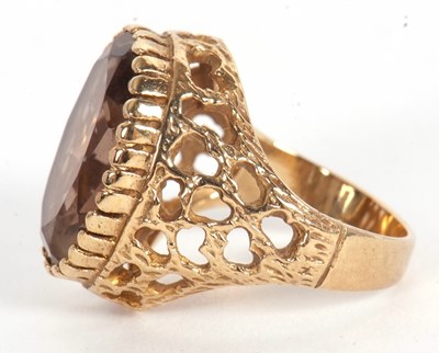 Lot 51 - A 9ct smokey quartz ring, the oval smokey...