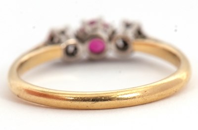 Lot 64 - A ruby and diamond ring, the central round...