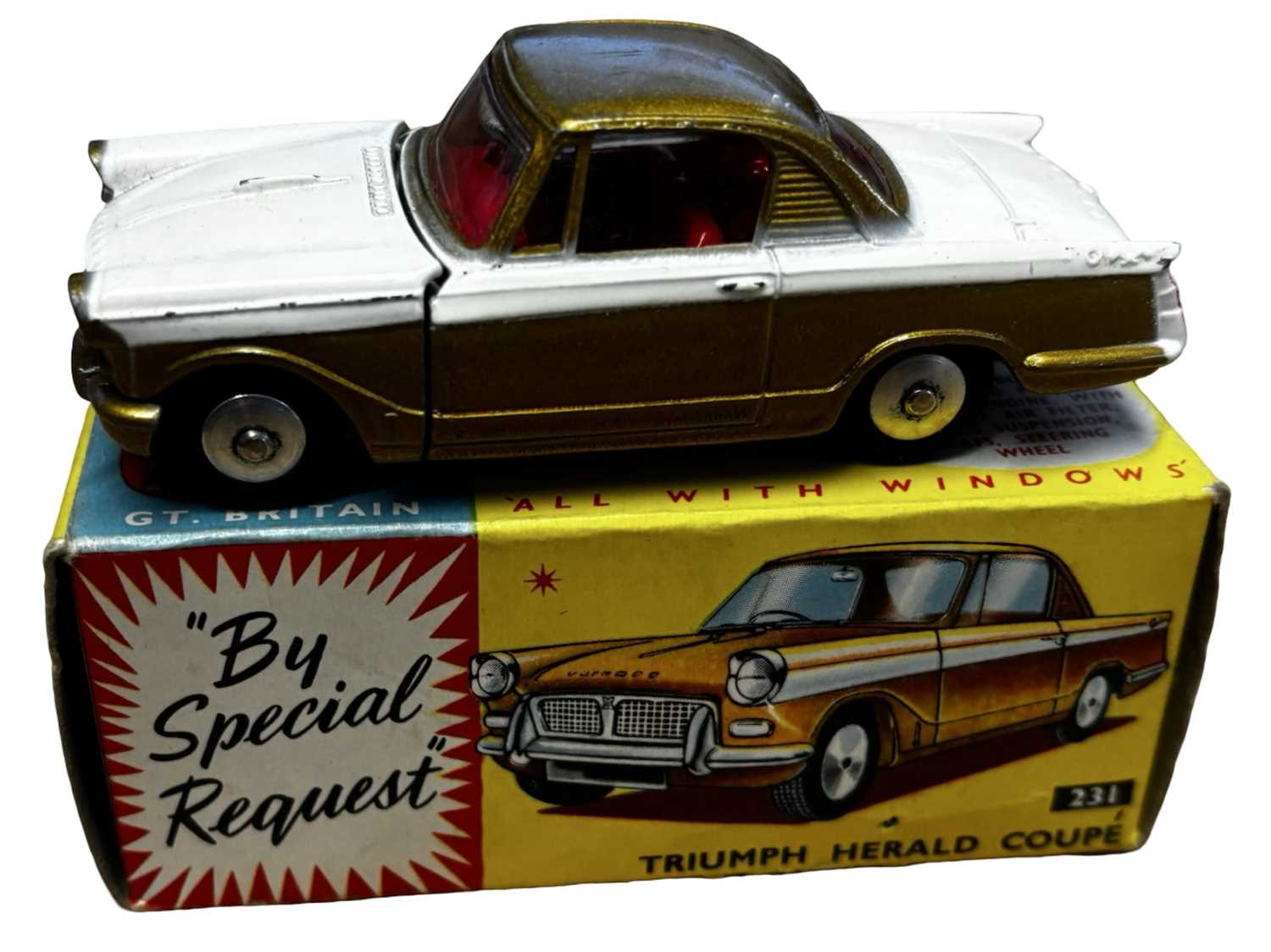 Lot 65 - A boxed Corgi 231 Triumph Herald Coupe in gold...