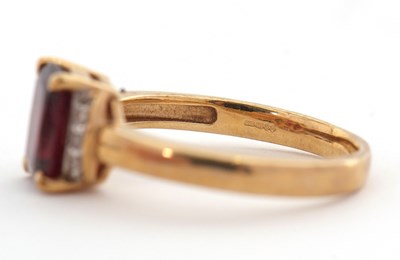 Lot 26 - A 9ct garnet and diamond ring, the modified...