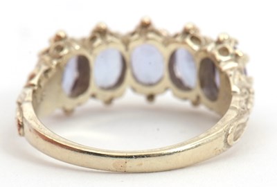 Lot 90 - A 9ct tanzanite ring, with five oval...