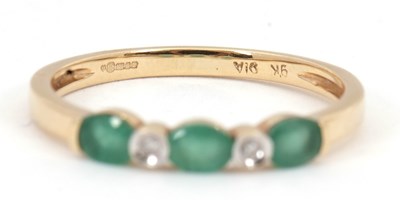 Lot 89 - A 9ct emerald and diamond ring, set with three...