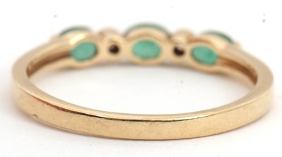 Lot 89 - A 9ct emerald and diamond ring, set with three...