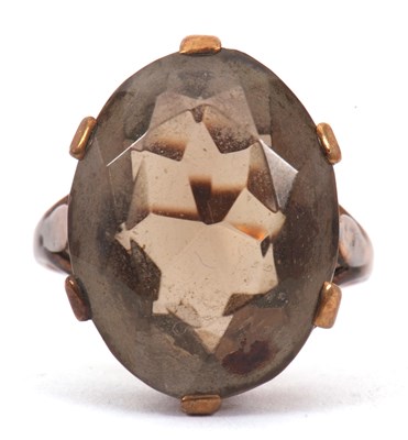 Lot 23 - A 9ct smokey quartz ring, the oval smokey...