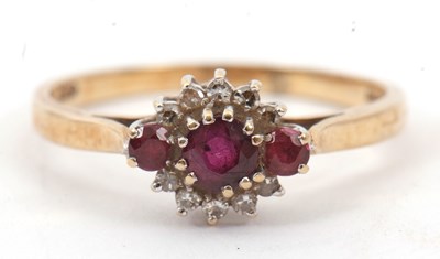 Lot 21 - A 9ct ruby cluster ring, the central round...