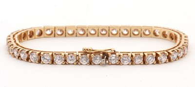 Lot 94 - A CZ line bracelet, set with 41 round CZ's in...