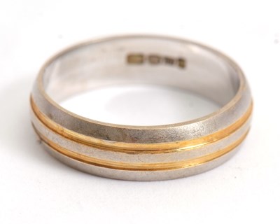 Lot 213 - A two-tone 18ct gold ring, the white gold band...