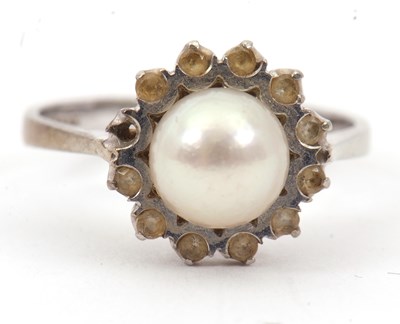 Lot 24 - A cultured pearl ring, the central cultured...