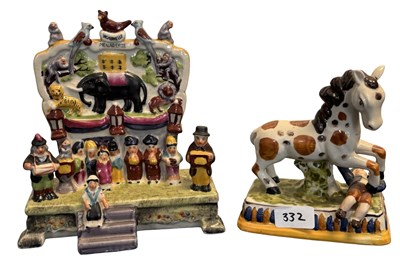 Lot 357 - A pair of Staffordshire-style circus animal...