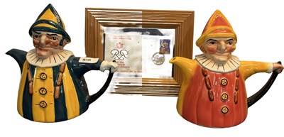 Lot 371 - A pair of large Punch and Judy teapots,...