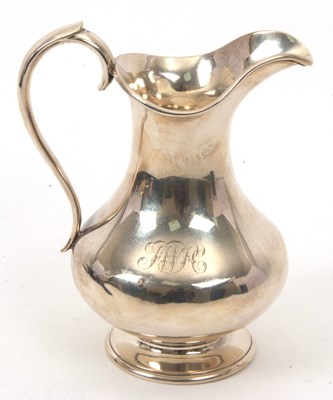 Lot 4 - A Victorian silver jug of plain baluster form...