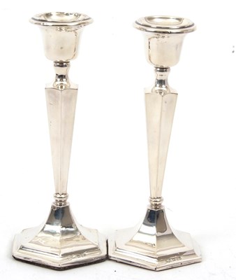 Lot 55 - A pair of George V silver candlesticks of...