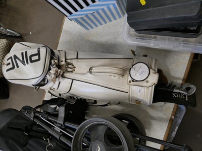 Lot 783 - A Ping gold caddy and clubs