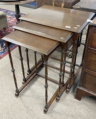 Lot 486 - A 20th Century nest of three oak tables on...