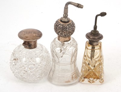 Lot 186 - Two cut glass and sterling mounted atomisers...