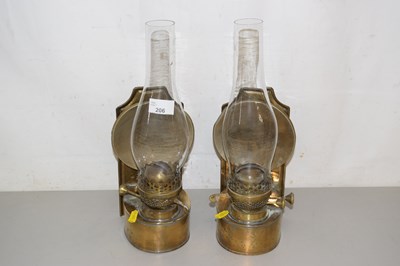 Lot 206 - A pair of brass sconce oil lamps