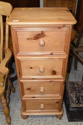Lot 284 - Modern waxed pine narrow chest of four drawers...