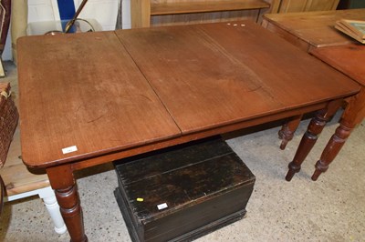 Lot 343 - An extending rectangular dining table with...