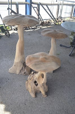 Lot 150 - A set of three large carved wooden mushroom,...