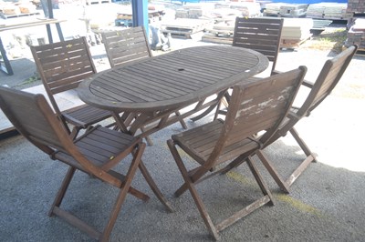 Lot 216 - A hardwood oval patio table and set of six...