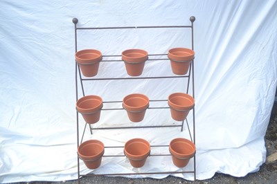 Lot 185 - A nine pot metal plant stand, width approx 62cm