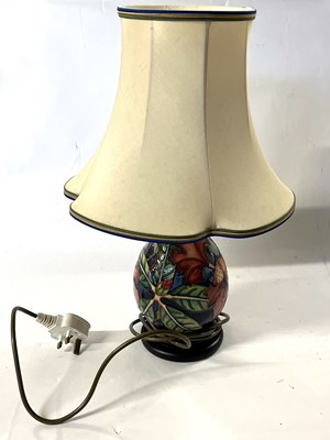Lot 243 - A Moorcroft lamp with tubelined floral design...