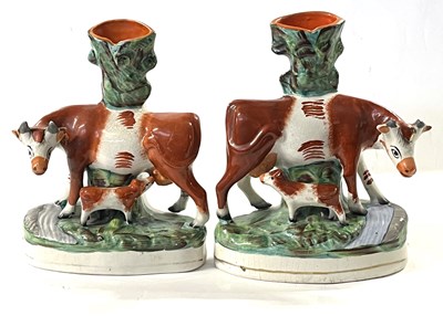 Lot 244 - Two Staffordshire spill vases both decorated...