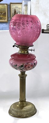 Lot 299 - A late 19th Century oil lamp with pink shade...