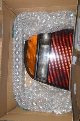 Lot 881 - Box containing rear lamp cluster for a VW Golf...