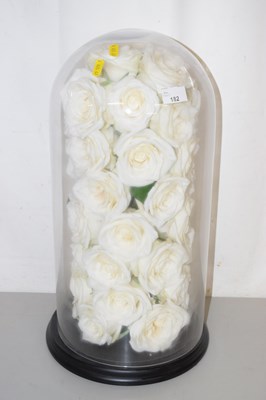 Lot 182 - A spray of fake white roses under a glass dome