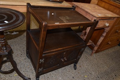 Lot 302 - An oak tea trolley with cupboard base
