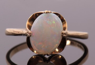 Lot 10 - A 9ct opal ring, the oval opal cabochon in...