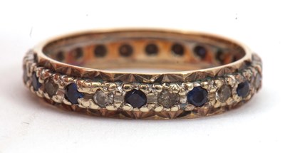 Lot 15 - A sapphire and white stone eternity ring, with...