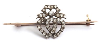 Lot 111 - A diamond heart bar brooch, with two old mine...