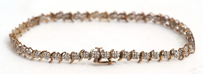 Lot 93 - A 9ct diamond line bracelet, the small round...