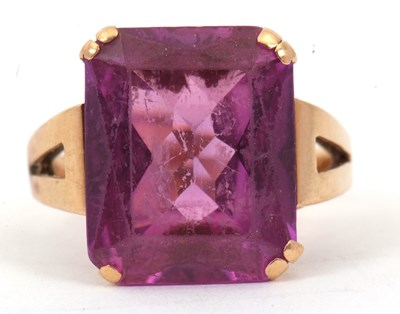 Lot 26 - A purple stone ring, the modified emerald cut...